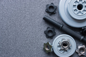 dumbbell for bodybuilding on a gray background