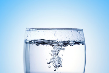 pouring water into a glass closeup with copy space