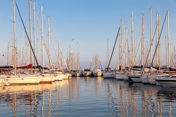 Fototapeta na wymiar beautiful white modern yachts at sea port in sunset time
