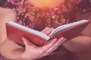 Cropped shot of young woman reading a book