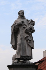 Fototapeta premium Statue of St. Philip Benitius on the Charles Bridge in Prague, Czech Republic
