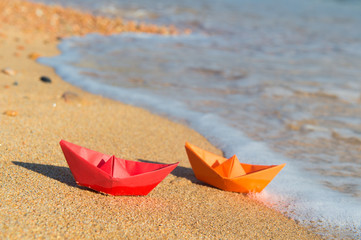 Fototapeta na wymiar Paper boats at the beach