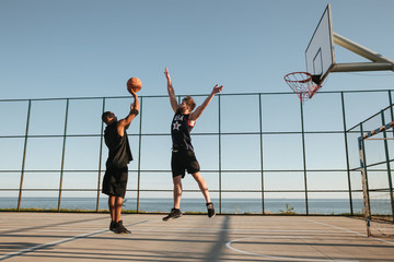 Two sportsmen playing basketball