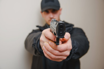 Man hold gun in hand close-up.