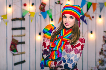 Young model in colorful hat and gloves