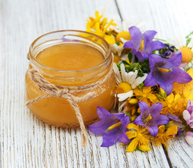 Jar of honey with wildflowers