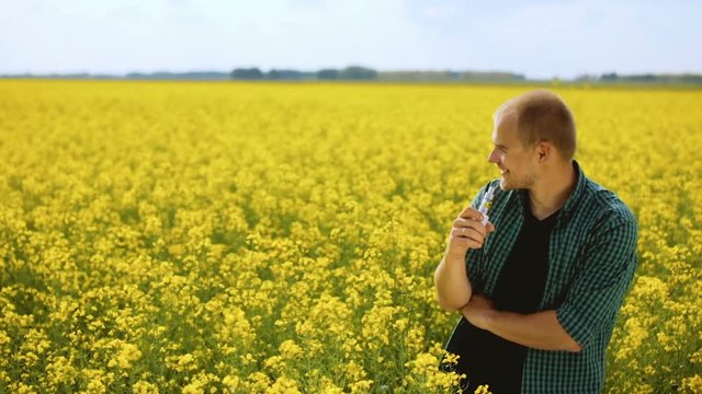 young man is vaping in yellow field
