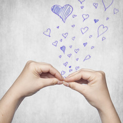 two hands performing a gesture kiss