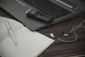 journalist's work at a computer with a voice recorder