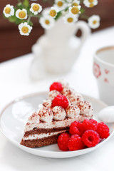 cake with raspberries on a background of daisies