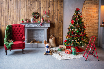 Christmas decorations. a comfortable armchair with a rug, gifts, Christmas Tree, fireplace Christmas.The concept of Christmas