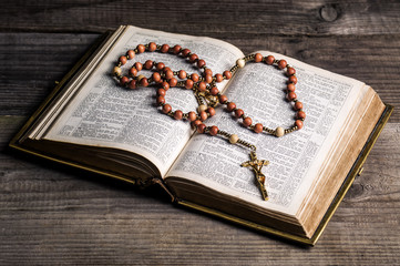 rosary on old Bible