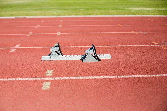 Starting block on a running track - Powered by Adobe