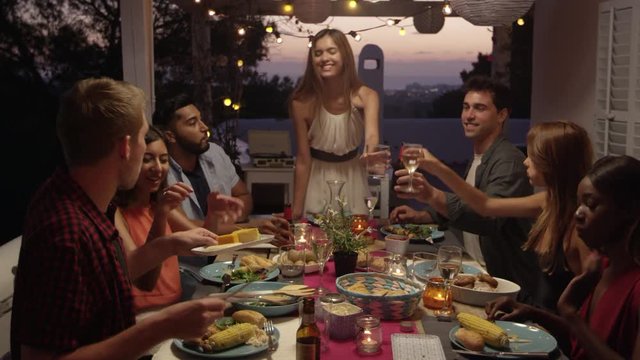 Friends make a toast over dinner on a roof terrace, Ibiza, shot on R3D