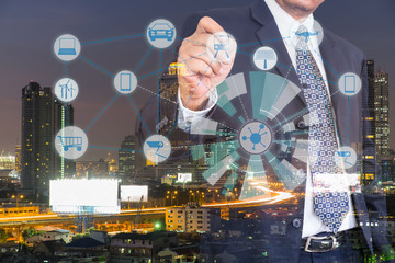 Internet of Things, Smart city  and Cyber - Physical system concept. Smart things icons mesh on double exposure of business man and city traffic night background.