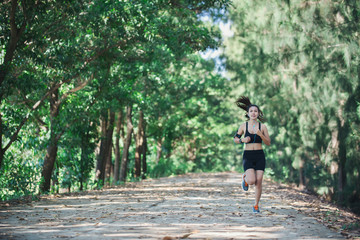 Young fitness woman jogging in park.