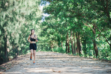 Fototapeta na wymiar Young fitness woman jogging in park.