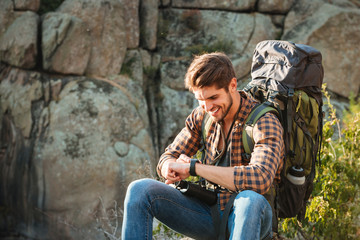 Close up tourist man sitting on rock