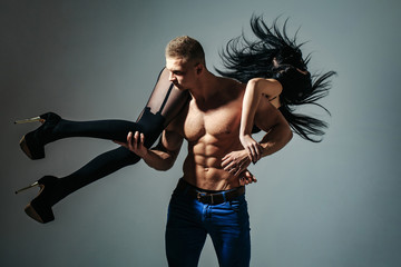 Fototapeta na wymiar muscular man and sexy girl