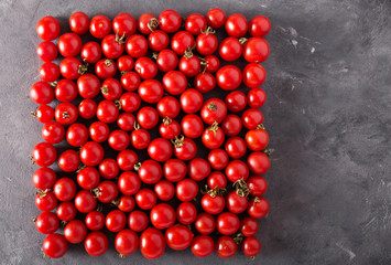 Cherry tomatoes in a square form. Colorful tomatoes Tomatoes background. Fresh tomatoes Healthy food concept. Colorful festive still life. Loosely laid tomatoes in different positions.