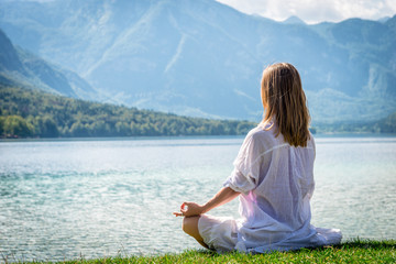 Woman meditating at the lake