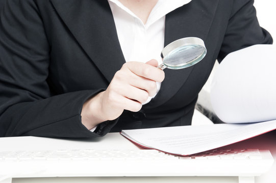 Businesswoman Holding Magnifying Glass