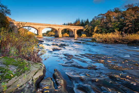 Bywell Bridge crosses River Tyne, as it flows through Northumberland, under the stone arched Bywell Road Bridge near Stocksfield