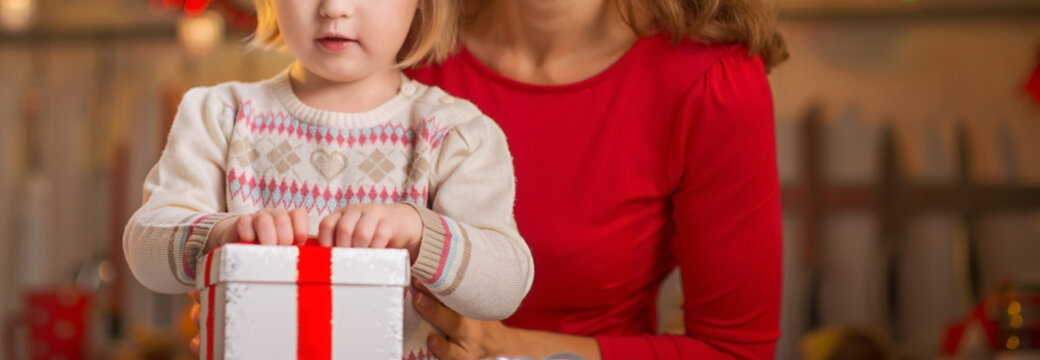 Closeup On Happy Mother And Baby Opening Christmas Present Box