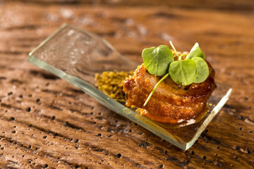Pork ballotine with pururuca, water flour, pumpkin puree and sprouts in a spoon. Taste gastronomy fingerfood