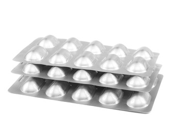 Pills in blister packs on white background.