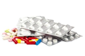 Pills in blister packs on white background.
