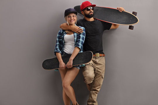 Skaters posing with longboard and skateboard