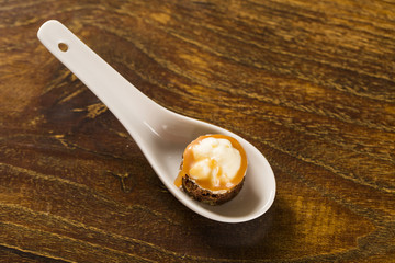 Brownie with cupuacu cream and salted caramel in a spoon. Taste gastronomy finger food