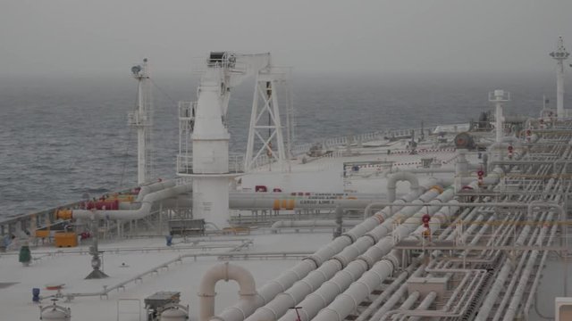 Deck of very large tanker, haze in Persian gulf.