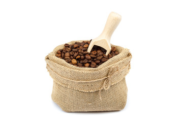 Coffee beans in canvas bag with wooden scoop