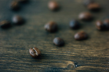 Coffee beans on black wooden board.