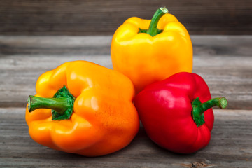 Fresh sweet bell peppers on wooden boards