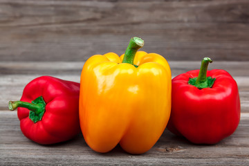 Fresh sweet bell peppers on wooden boards