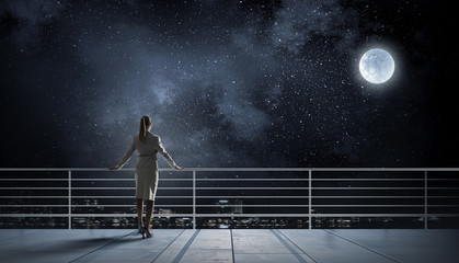 Businesswoman on building roof . Mixed media © Sergey Nivens