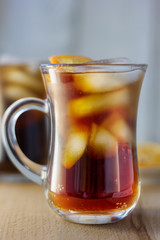 Glass of rum and cola with the ice cubes and slice of orange.