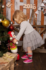  little girl near the Christmas tree at home