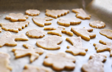 Fototapeta na wymiar Christmas cookies or christmas baking with cookie dough and christmas ornaments. Cookie cutters.