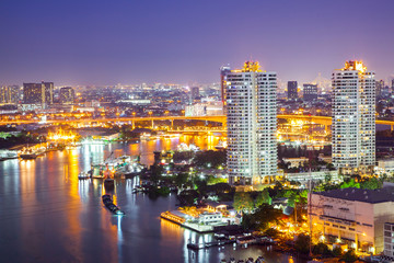 Fototapeta na wymiar The City of Chaopraya river with light and reflection in twilight. Bangkok, Thailand