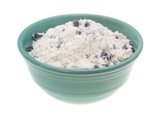 Bowl of blueberry muffin mix on a white background.