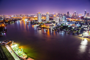 The City of Chaopraya river with light and reflection in twilight. Bangkok, Thailand