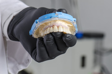 Dental technician holding a monolithic zirconia