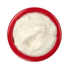 Bowl of cocoa butter cream skin lotion top view isolated on a white background.
