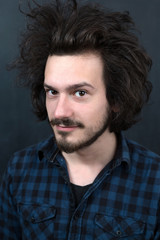 Portrait of a fashionable young man on dark background, chalkboa