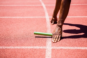Hands of athlete holding baton
