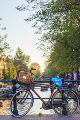 Naklejka premium Vintage bicycle in dutch canal cityscape, The Netherlands